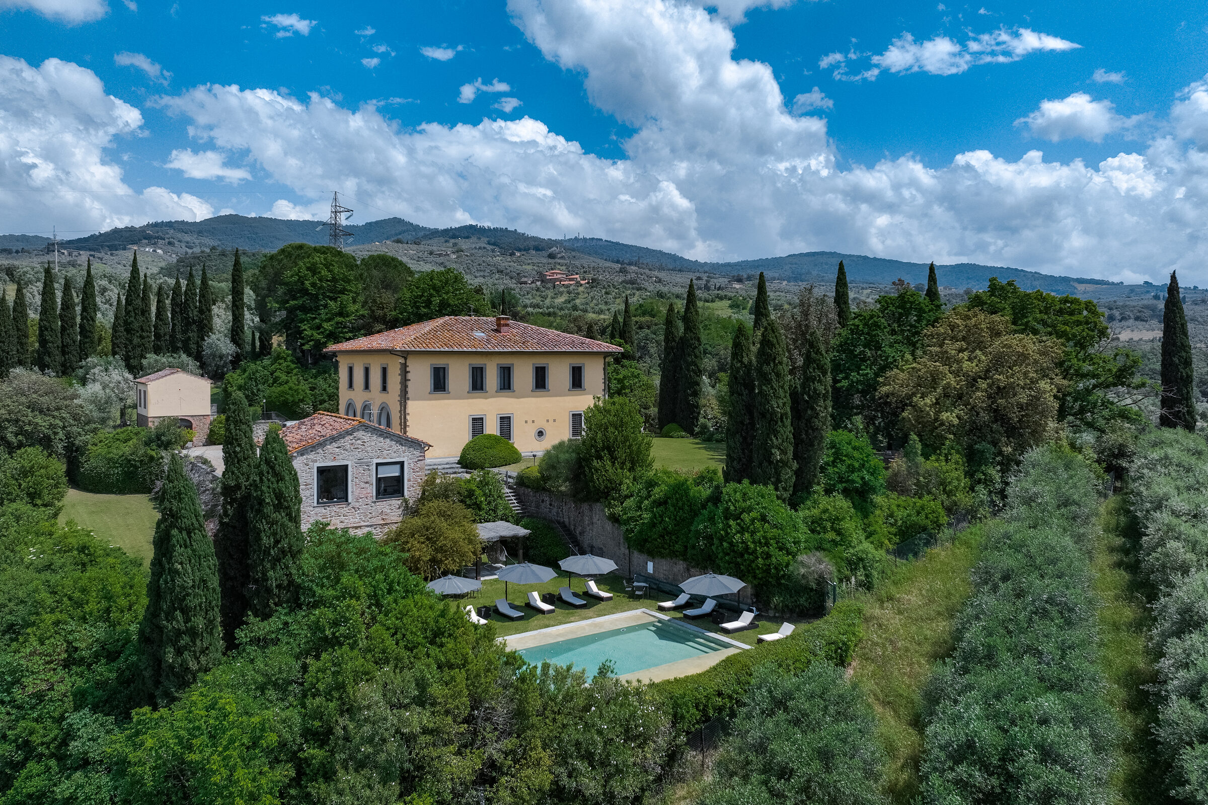 Aerial of the villa with pool, set in olive groves